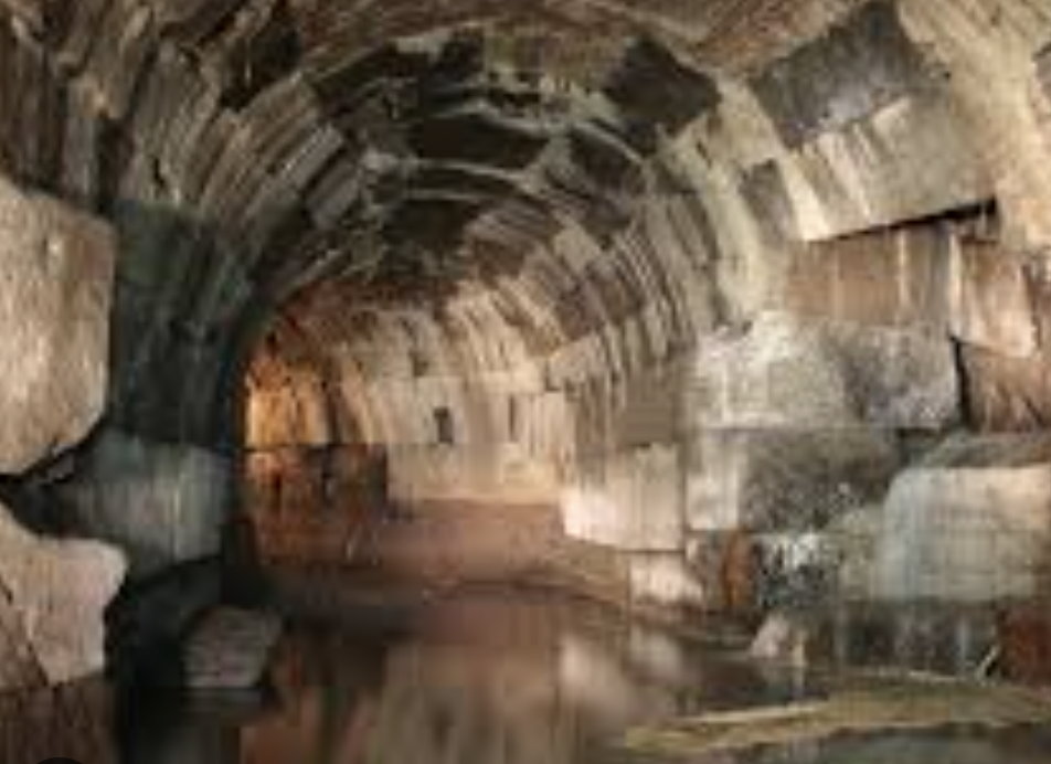 Interior of the Cloaca Maxima — a vaulted Roman stone tunnel still carrying water beneath the Forum
